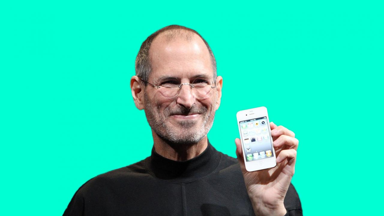 Steve jobs holding an iphone